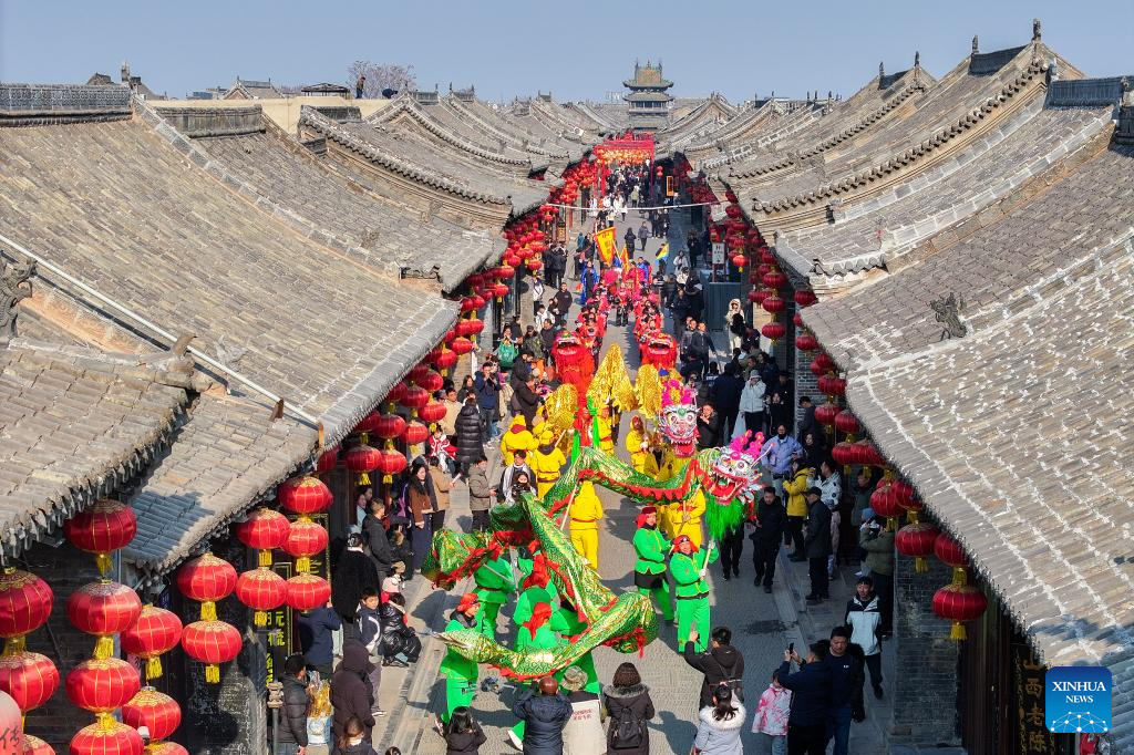 People immerse themselves in traditional customs and partake in festivities before Spring Festival across China