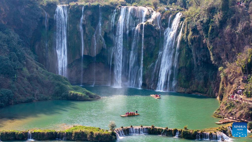 Tourists have fun at scenic area of Jiulong Waterfalls in SW China's Yunnan