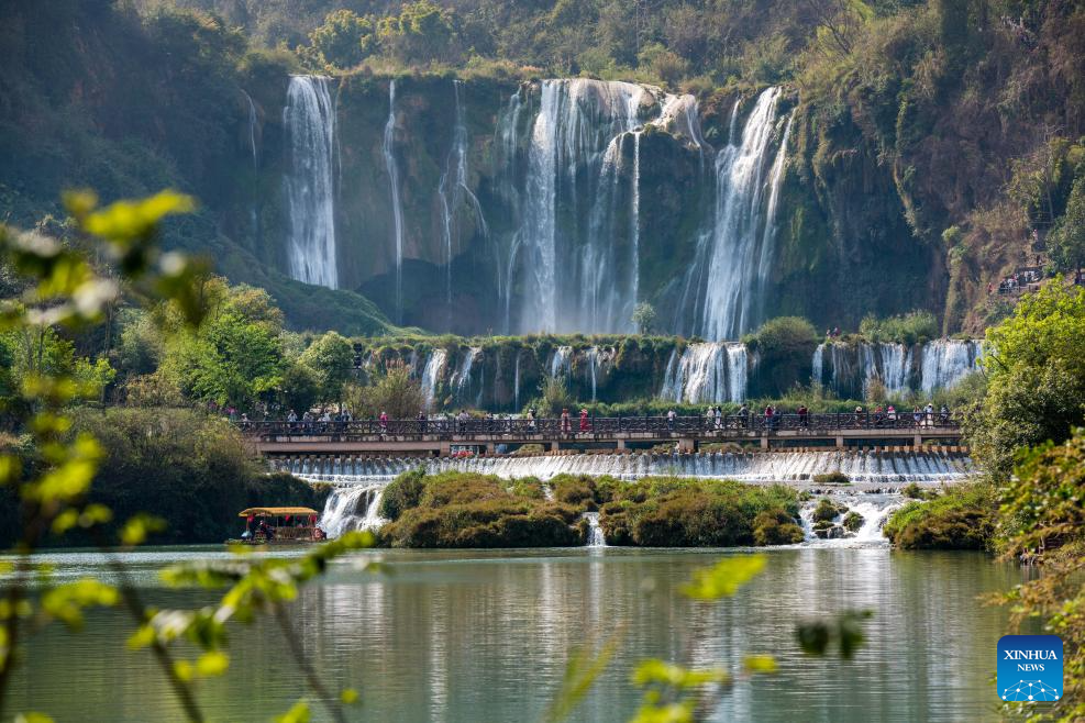 Tourists have fun at scenic area of Jiulong Waterfalls in SW China's Yunnan