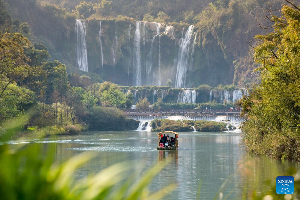 Tourists have fun at scenic area of Jiulong Waterfalls in SW China's Yunnan