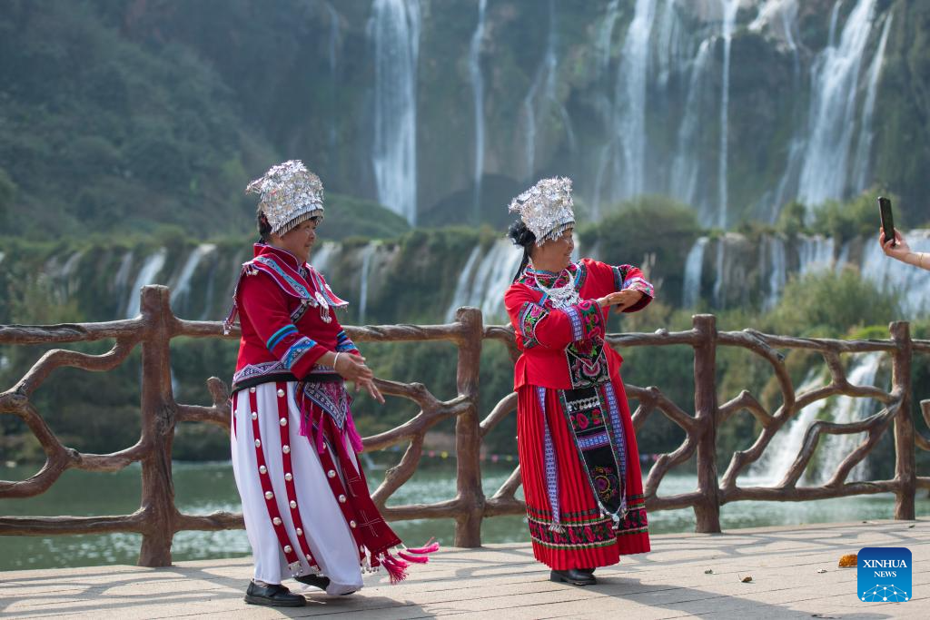 Tourists have fun at scenic area of Jiulong Waterfalls in SW China's Yunnan