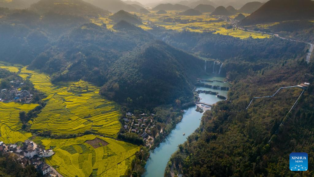 Tourists have fun at scenic area of Jiulong Waterfalls in SW China's Yunnan