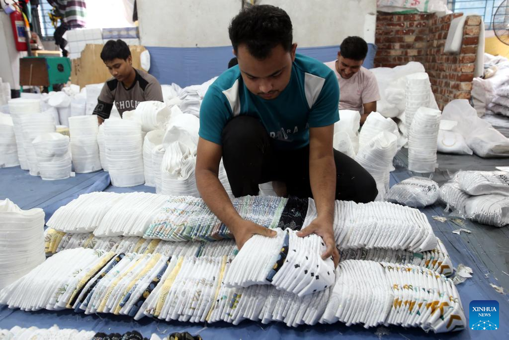 Workers produce prayer caps before Eid-ul-Fitr in Bangladesh