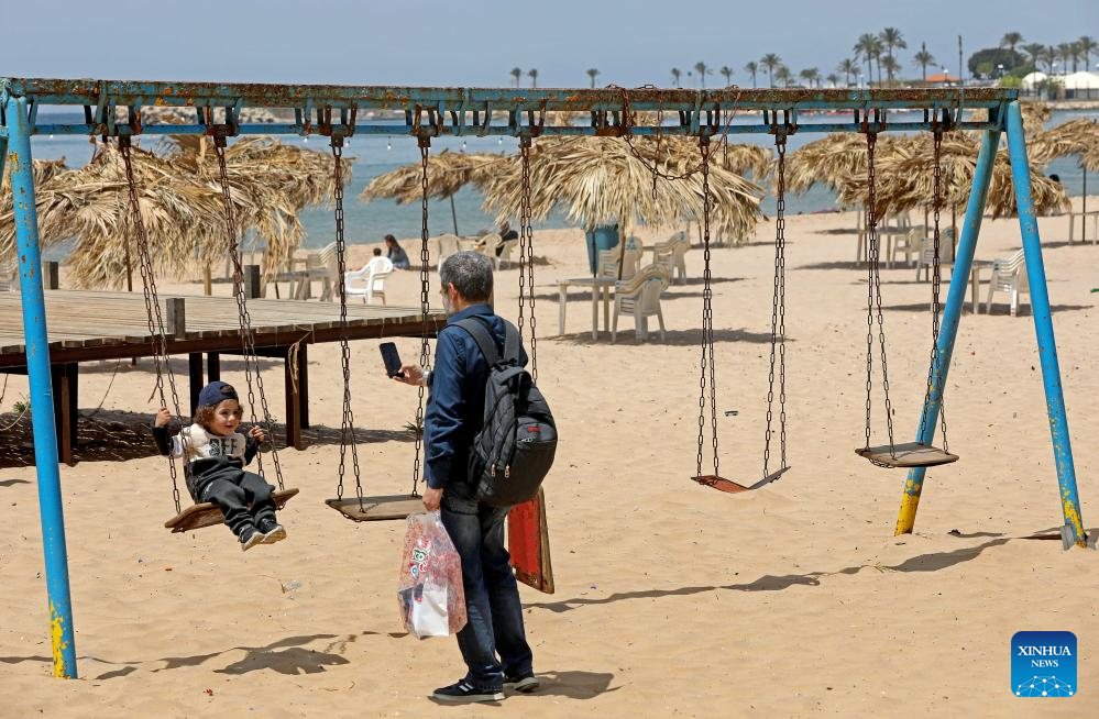 People enjoy themselves on beach in Beirut, Lebanon