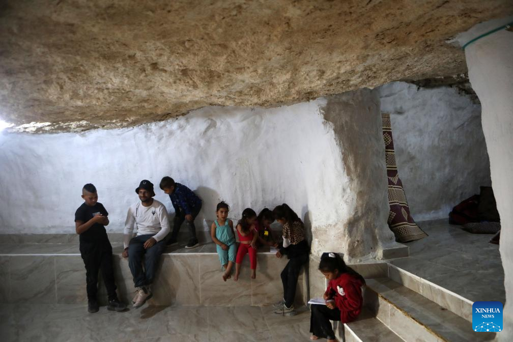 Palestinians seen in Hebron's village after Israeli forces demolish their structures