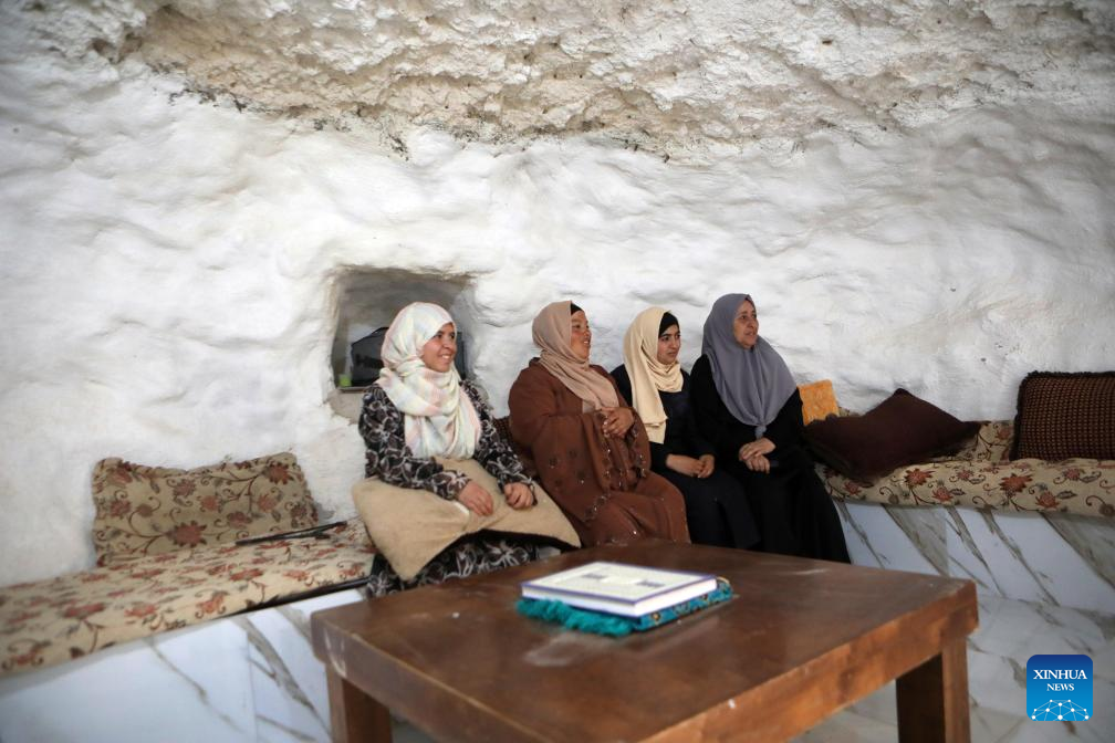 Palestinians seen in Hebron's village after Israeli forces demolish their structures