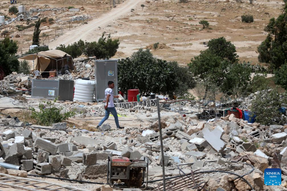 Palestinians seen in Hebron's village after Israeli forces demolish their structures