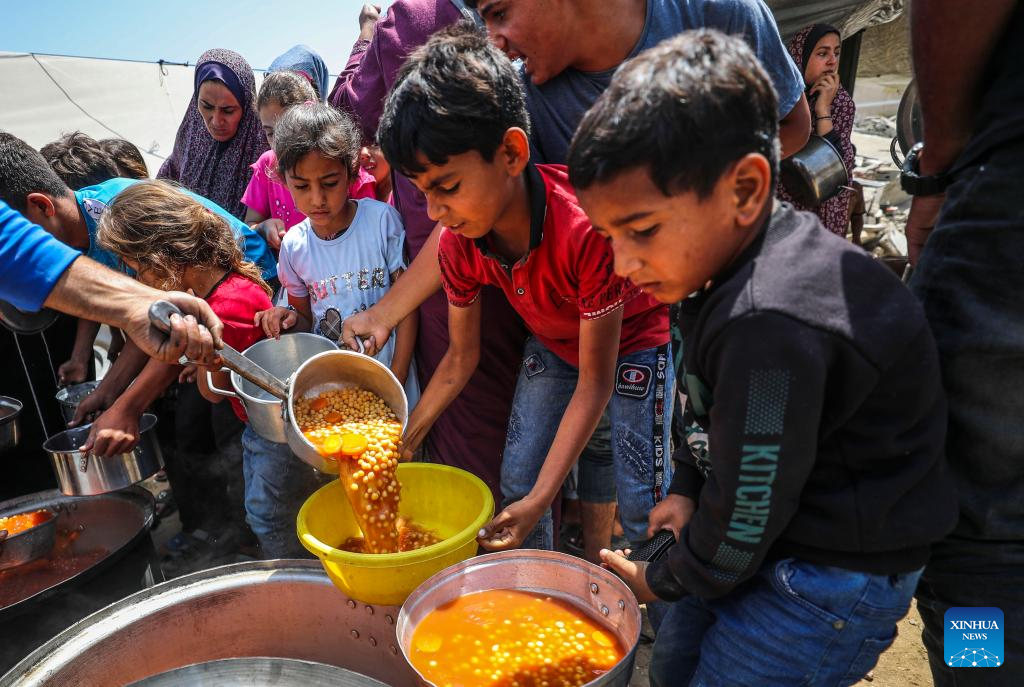Palestinians receive free food at food distribution center in Gaza City