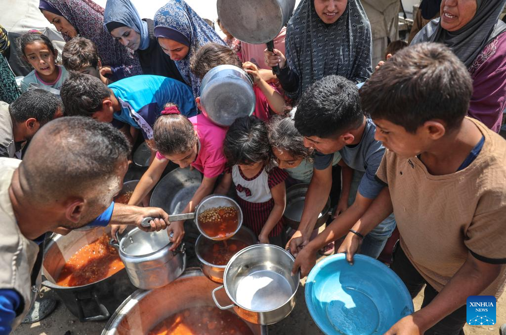 Palestinians receive free food at food distribution center in Gaza City