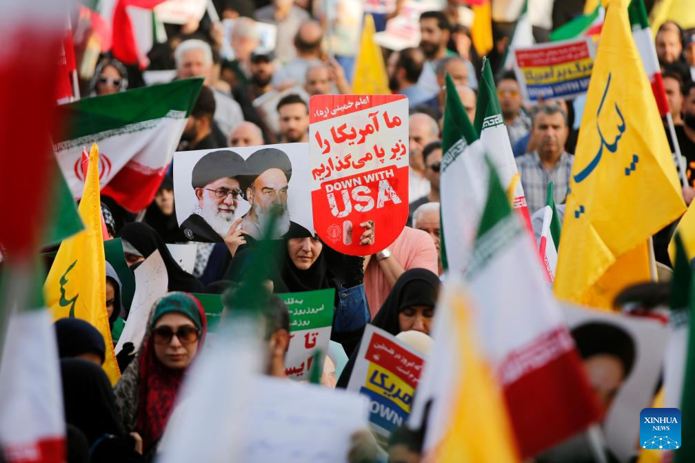 People celebrate ceasefire between Iran, Israeal at Enghelab Square in Tehran