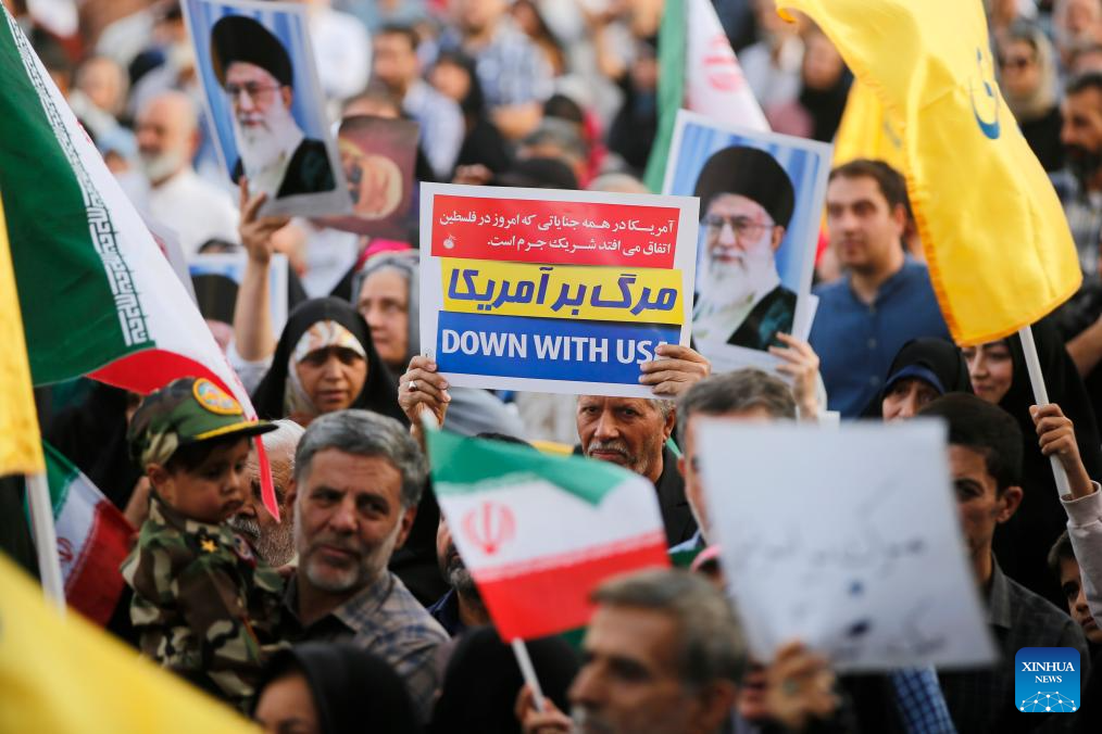 People celebrate ceasefire between Iran, Israeal at Enghelab Square in Tehran