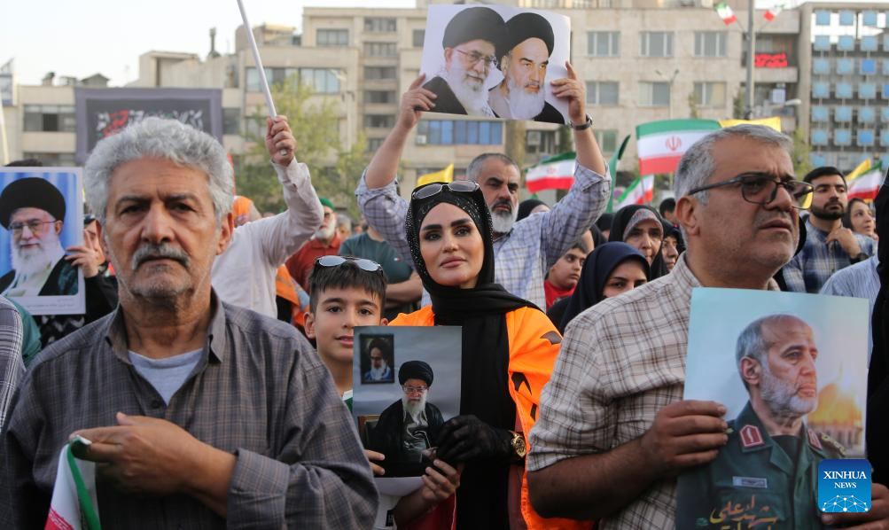 People celebrate ceasefire between Iran, Israeal at Enghelab Square in Tehran