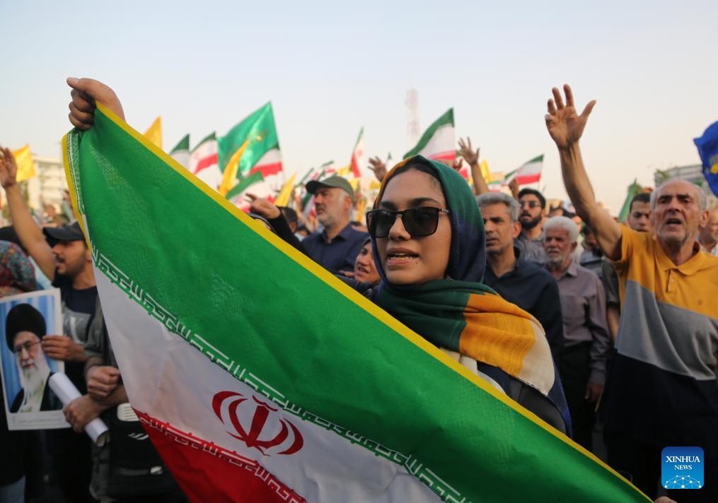 People celebrate ceasefire between Iran, Israeal at Enghelab Square in Tehran