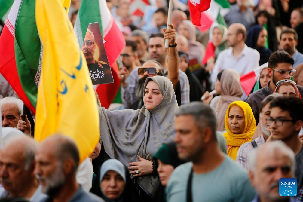 People celebrate ceasefire between Iran, Israeal at Enghelab Square in Tehran