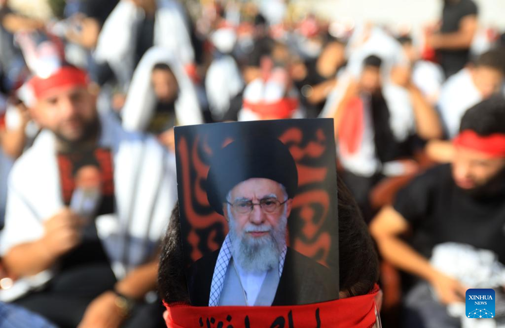 Lebanese people gather outside Iranian Embassy carrying pictures of Iranian Supreme Leader