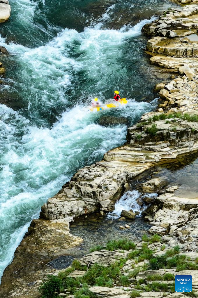 People raft in inflatable boats on Luobei River in Guizhou