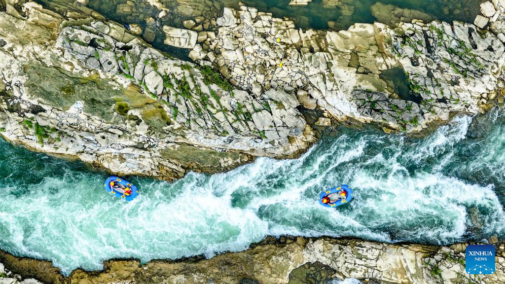 People raft in inflatable boats on Luobei River in Guizhou