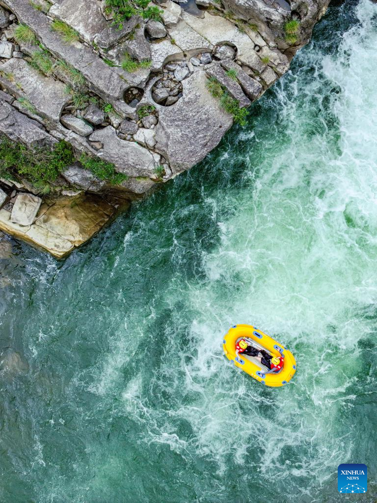 People raft in inflatable boats on Luobei River in Guizhou