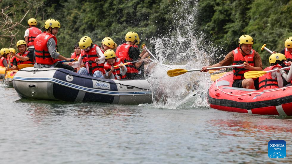 People raft in inflatable boats on Luobei River in Guizhou