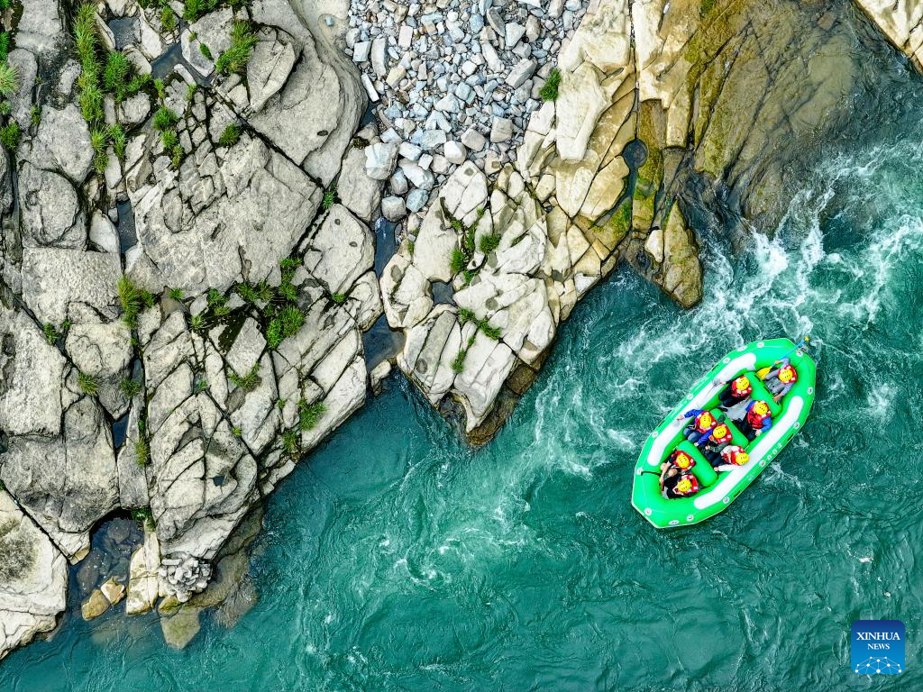 People raft in inflatable boats on Luobei River in Guizhou