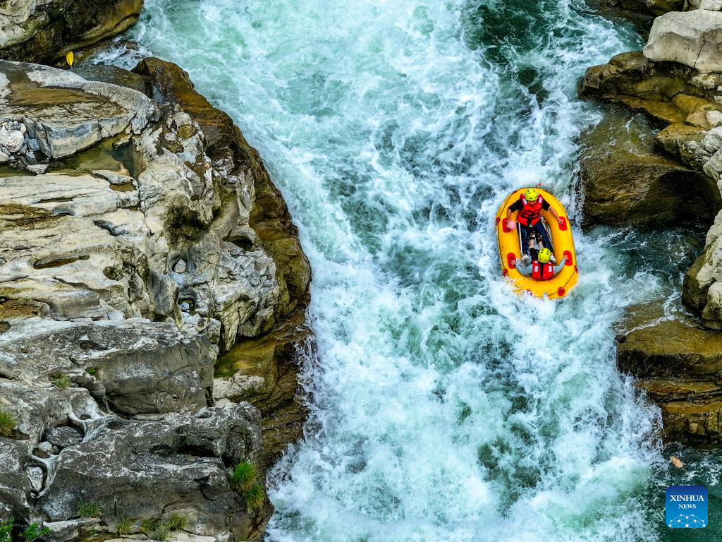 People raft in inflatable boats on Luobei River in Guizhou