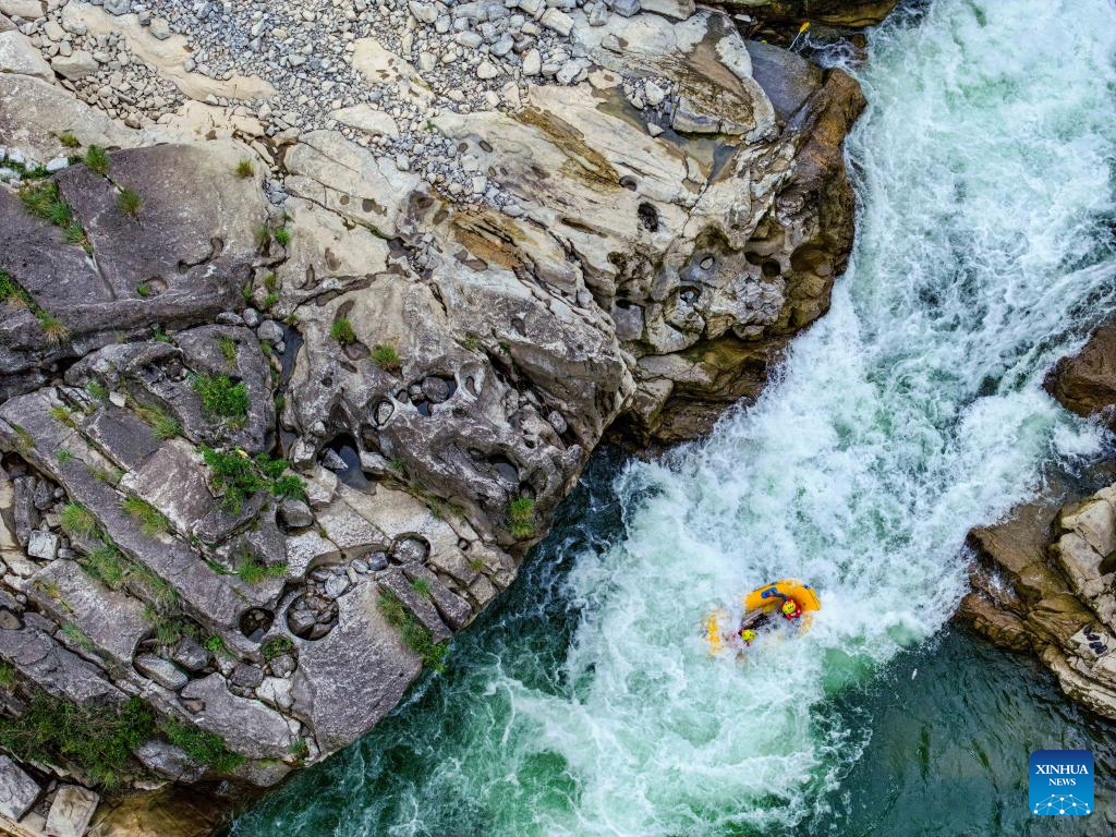 People raft in inflatable boats on Luobei River in Guizhou