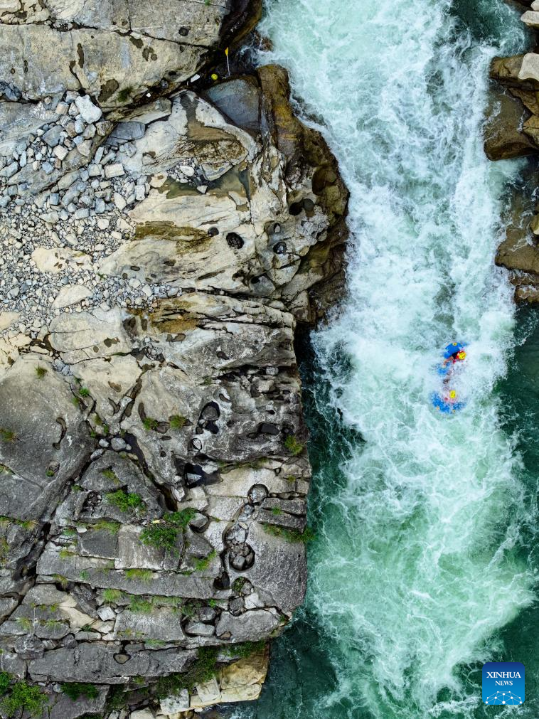 People raft in inflatable boats on Luobei River in Guizhou