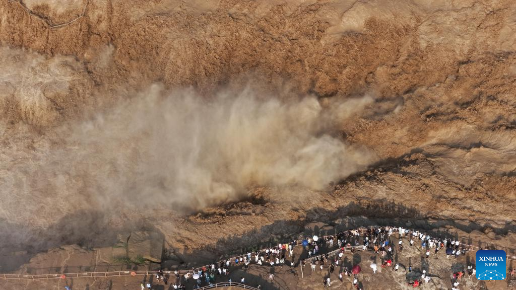 People visit Hukou Waterfall on Yellow River in Jixian County, north China