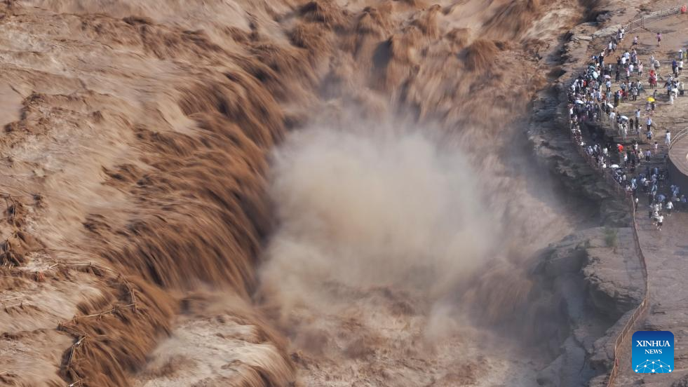 People visit Hukou Waterfall on Yellow River in Jixian County, north China