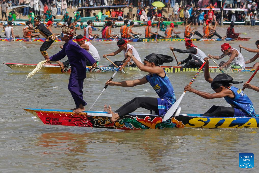 People participate in long boat race to celebrate Pacu Jalur Festival in Indonesia
