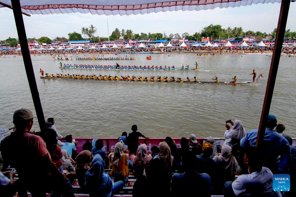 People participate in long boat race to celebrate Pacu Jalur Festival in Indonesia