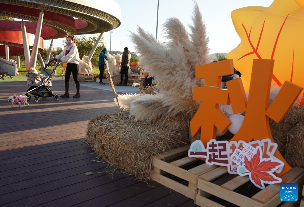 People enjoy leisure time by Yongding River in Beijing