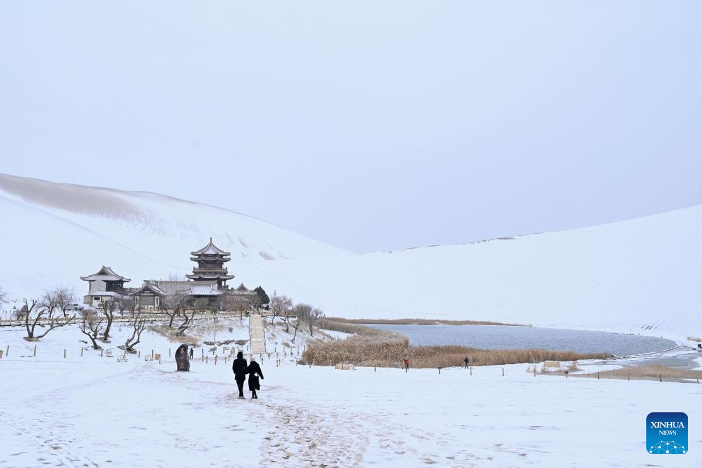 Tourists visit Mingsha Mountain and Crescent Spring Scenic Area in Dunhuang City, NW China