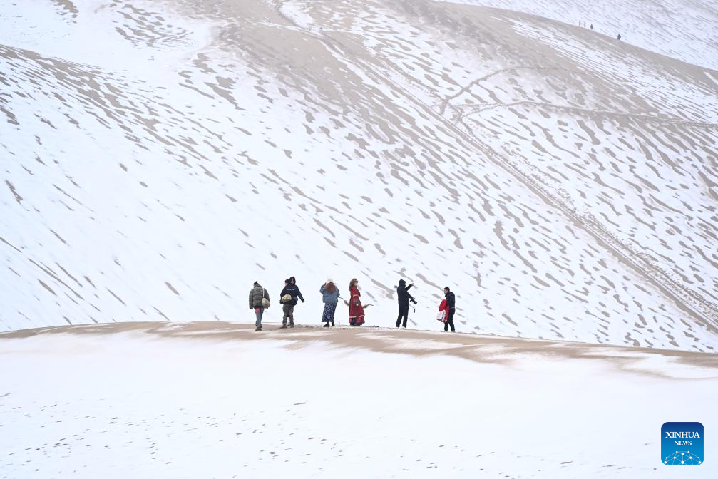 Tourists visit Mingsha Mountain and Crescent Spring Scenic Area in Dunhuang City, NW China
