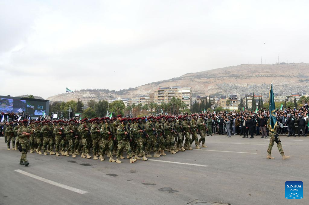 Syria's interim authorities mark first year of political transition with military parade