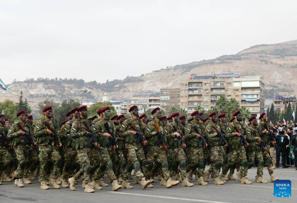 Syria's interim authorities mark first year of political transition with military parade