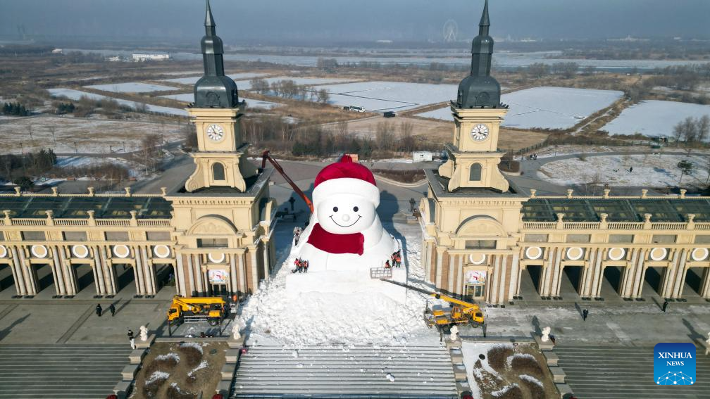 Workers build giant snowman in Harbin, China's Heilongjiang