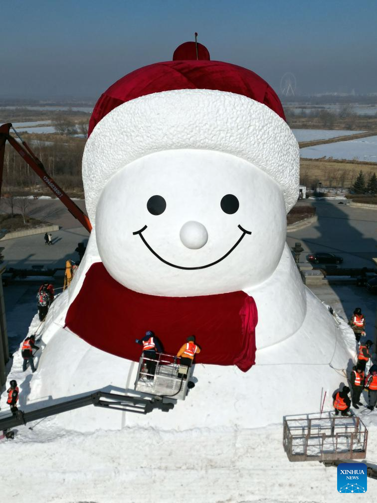 Workers build giant snowman in Harbin, China's Heilongjiang