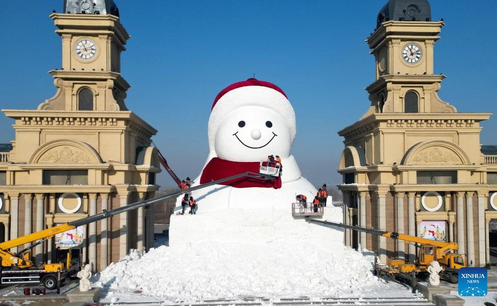 Workers build giant snowman in Harbin, China's Heilongjiang