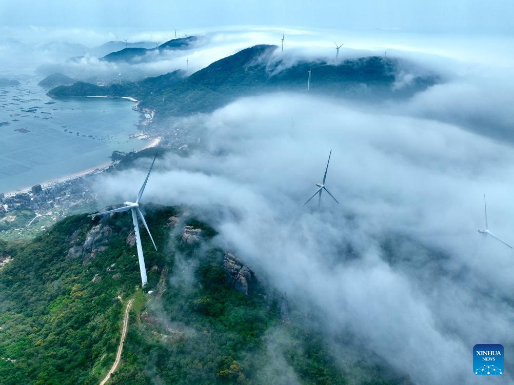 Aerial view of wind farm shrouded in fog in Lianjiang, China's Fujian