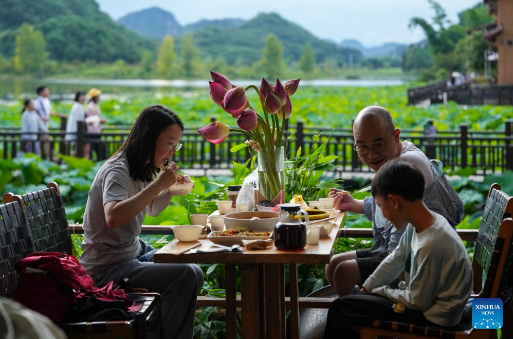 China's Puzhehei scenic area attracts tourists during summer travel season