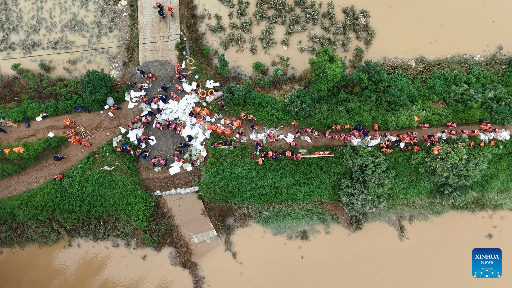 Thousands evacuated as heavy rain swells rivers in central China