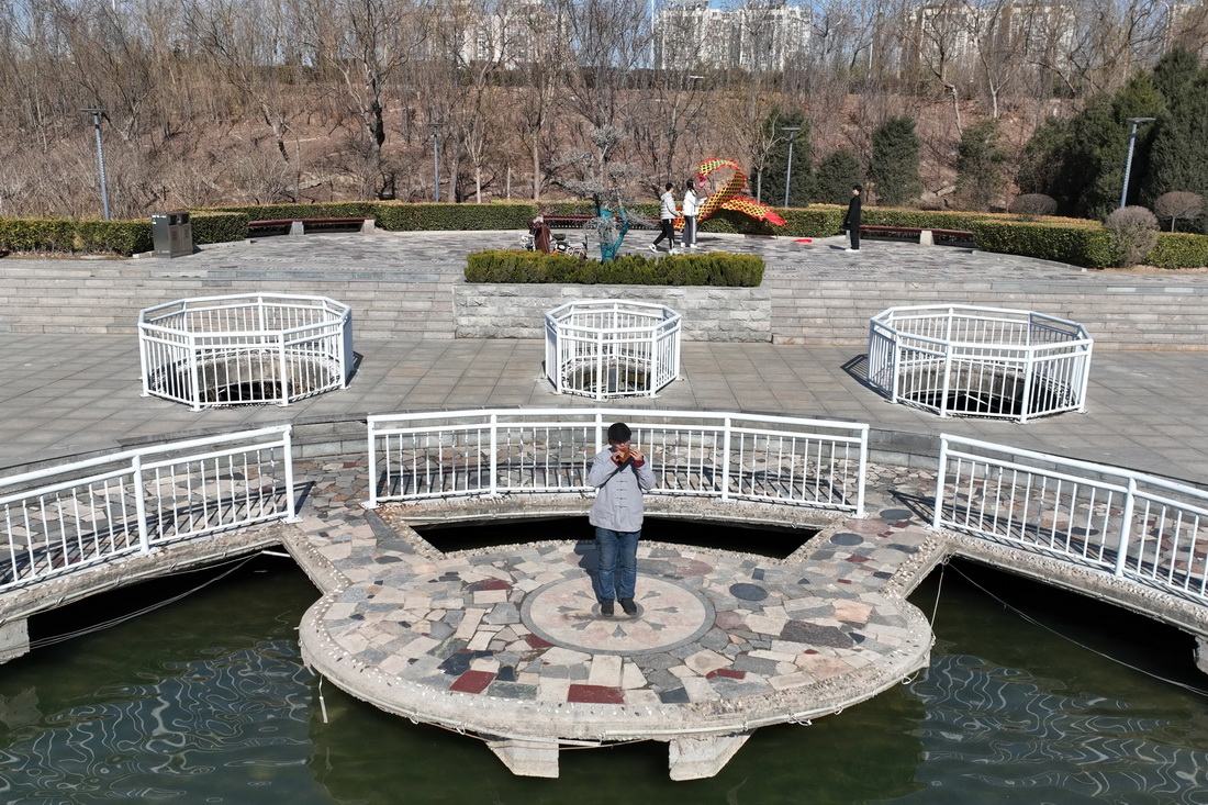 2月20日，陶笛艺人侯义敏在河北省邢台市一公园内吹奏木质陶笛（无人机照片）。